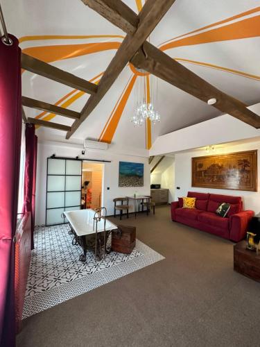 a living room with a red couch and a table at Eclectic 6 in Satu Mare