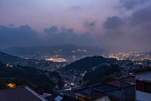 a view of a city at night at Nagasaki Night View Stay 長崎絶景ステイ - Lotus長崎 in Nagasaki