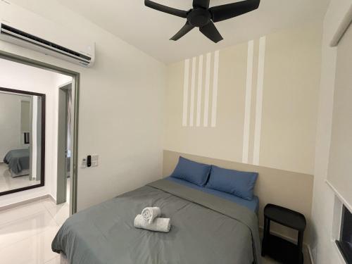 a bedroom with a bed and a ceiling fan at Central Park Damansara Near KPJ, 1Utama, The Curve by The Homez in Petaling Jaya