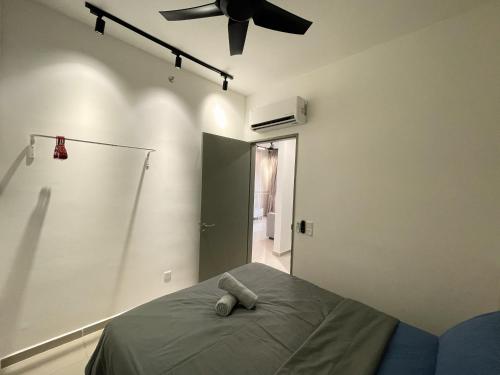 a bedroom with a bed and a ceiling fan at Central Park Damansara Near KPJ, 1Utama, The Curve by The Homez in Petaling Jaya