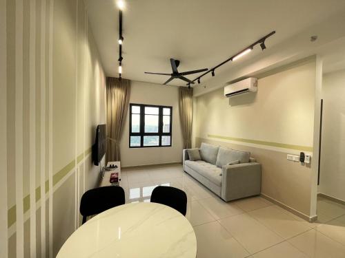 a living room with a table and a couch at Central Park Damansara Near KPJ, 1Utama, The Curve by The Homez in Petaling Jaya