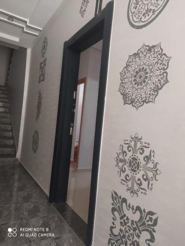 a hallway with mandala stencils on the wall at Bouznika mandarona in Bouznika