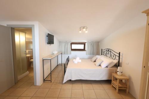 a bedroom with a bed with two pillows on it at Agriturismo Pietragrande in Otranto