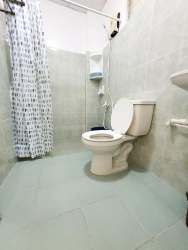 a bathroom with a toilet and a shower at Resort Manuela Panglao in Panglao Island