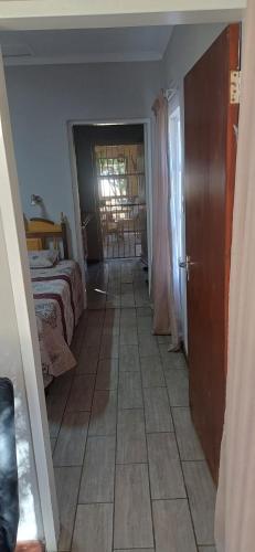 a bedroom with a bed and a door to a room at Olive rest in Wesselsbron