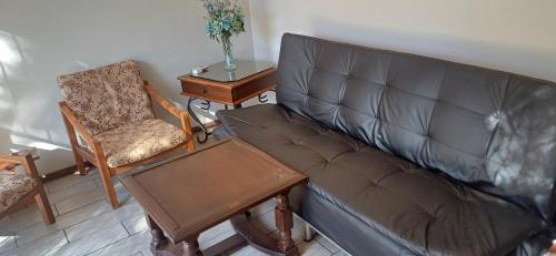 a living room with a couch and a chair at Olive rest in Wesselsbron