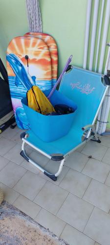 a blue chair with an umbrella sitting on a floor at Cute House with mountain views 