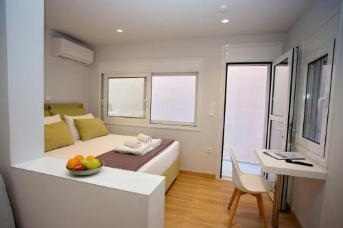 a bedroom with a bed and a bowl of fruit on a table at Emily in Athens - Central balconette flat with Starlink in Athens