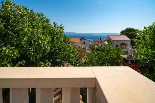 a view from the balcony of a house at Casa ol'Bol - Modern Apartment with Seaview and Private Large Backyard in Bol