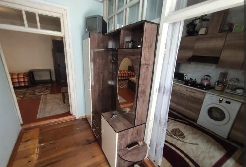 a living room with a large mirror in a house at Ulduzlu ev in Sheki