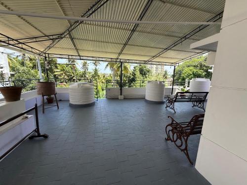 a room with benches and tables in a building at Bindas in Trivandrum