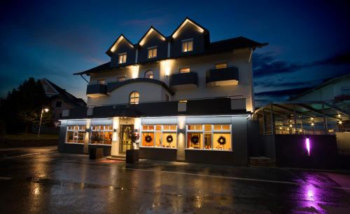 a building with a lot of windows at night at Hotel Landliebe in Söchau
