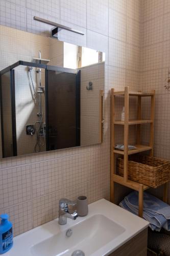 a bathroom with a sink and a shower and a mirror at CASA MIRELLA in Casale Monferrato