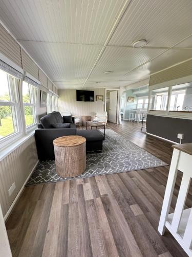 a living room with a couch and a table at Trolleys at Pebble Beach in Livonia