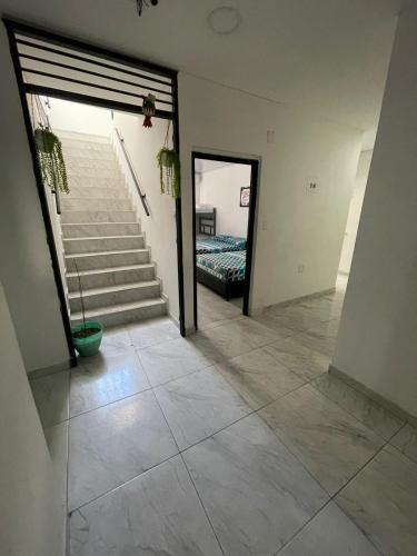 a hallway of a house with a staircase and a door at azul caribe 9-10-12-13 in Gaira