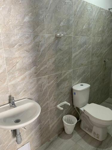 a bathroom with a toilet and a sink at azul caribe 9-10-12-13 in Gaira