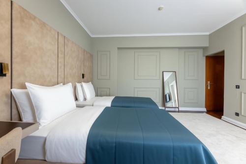 Postel nebo postele na pokoji v ubytování Hotel Majestic