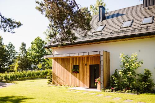 a house with a garage on the side of it at Zacisze Kaszuby in Gowidlino