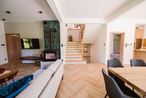 a living room with a couch and a fireplace at Zacisze Kaszuby in Gowidlino