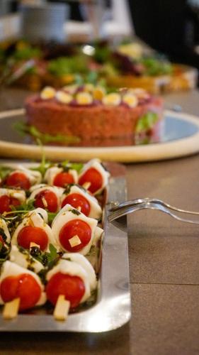a plate of food on a table with two pizzas at Hotel Landliebe in Söchau
