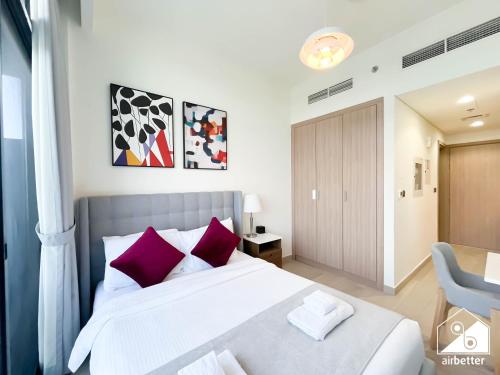 Un dormitorio con una cama grande con almohadas moradas. en Modern Comfort Studio Relax & Unwind in Style, en Dubái