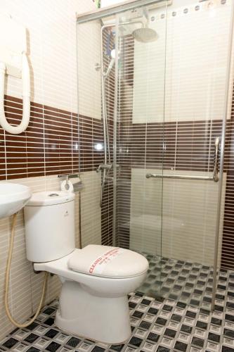 a bathroom with a toilet and a glass shower at CHIEN CONG Hotel in Ha Long