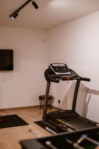 a gym with a treadmill in a room at Zacisze Kaszuby in Gowidlino