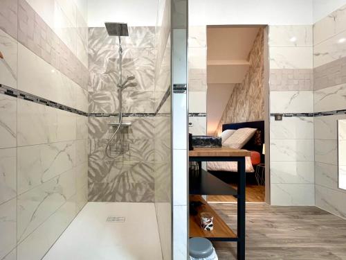 a bathroom with a shower with a glass door at Maison avec jacuzzi - Village paisible Sacy - LES NARCISSES in Vermenton