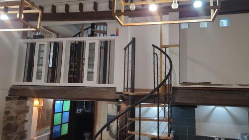 a spiral staircase in a building with a stained glass window at Holidays-Normandy - Ursula gîte 