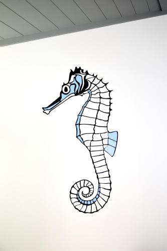 a drawing of a seahorse on a wall at Casa da Baía - Guest House in Horta