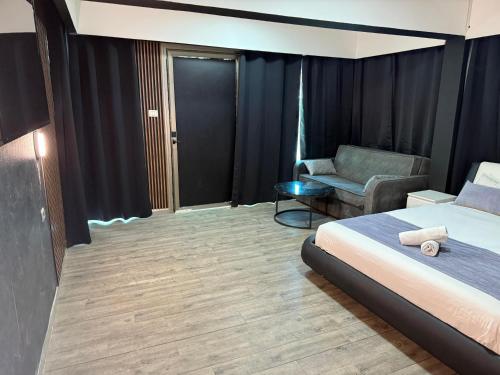 a hotel room with a bed and a chair at the royal lake views in Tiberias