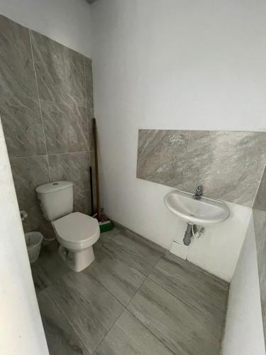 a bathroom with a toilet and a sink at azul caribe 9-10-12-13 in Gaira