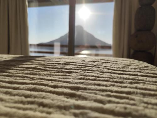a close up of a bed in a room with a window at Vouros Villages - Suites in Masouri