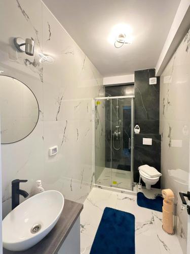 a bathroom with a sink and a shower at MatyMar Blue in Eforie Nord