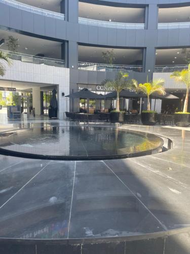 a large building with a fountain in front of it at Dar Residence - Madinaty B12 - U2 - 2 BR - New Cairo in Madinaty