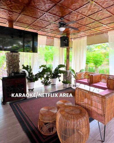 a living room with a table with chairs at Lovenista Retreat and Camping Site - Exclusive Stay near Canyoneering in Alegria