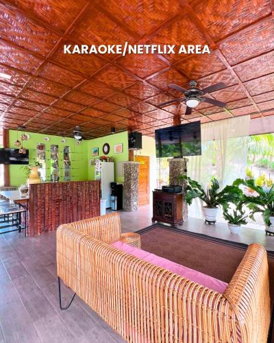 a living room with a couch and a tv at Lovenista Retreat and Camping Site - Exclusive Stay near Canyoneering in Alegria