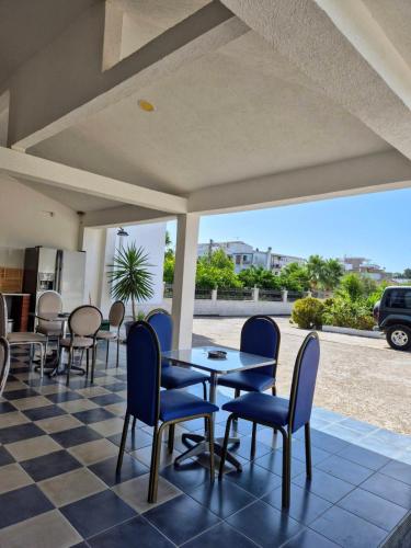 a patio with a table and chairs on a checkered floor at Apartments Yll in Ulcinj