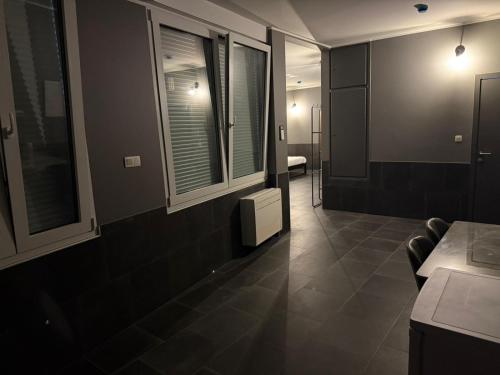 a room with a room with a table and windows at Logements des choraux in Tournai
