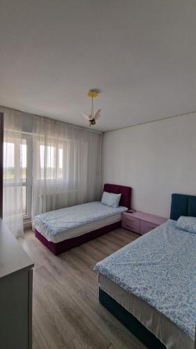 a bedroom with two beds and a ceiling at MMT SweetHome Sud in Ploieşti