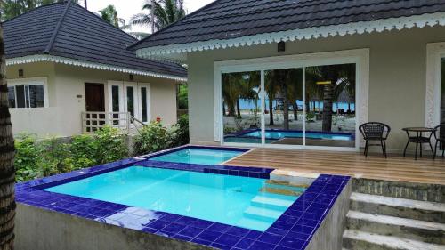 a swimming pool in the backyard of a house at Kikoi Boutique Hotel in Michamvi