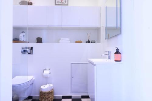 a white bathroom with a toilet and a sink at Best Stay Copenhagen Apartment 1550 in Copenhagen