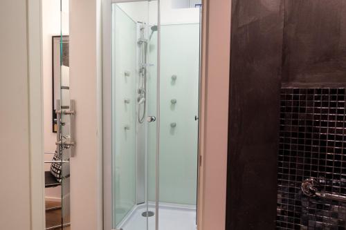 a glass shower in a bathroom with at B&B Il Bianco E Il Nero in Siracusa