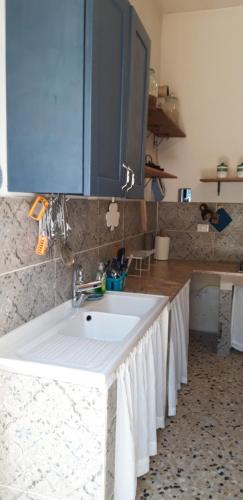 a kitchen with a white sink and a counter at Casa BLU in Torre Squillace