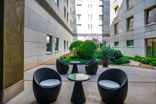 a courtyard with chairs and tables and a building at Continental Hotel Budapest in Budapest