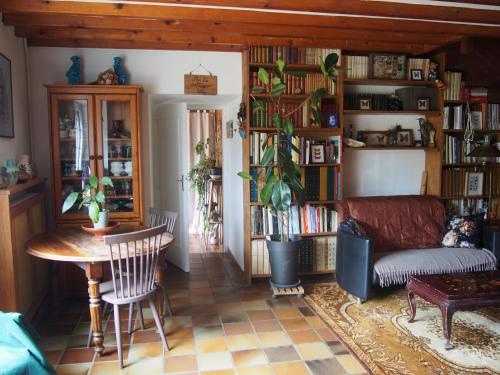a living room with a couch and a table at La Sorcière et le Korrigan in Paimpont