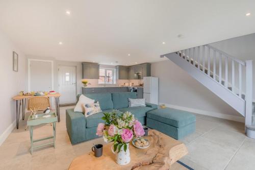 a living room with a couch and a table with flowers at 1 Bed in Marishes oc-l32534 in Kirby Misperton