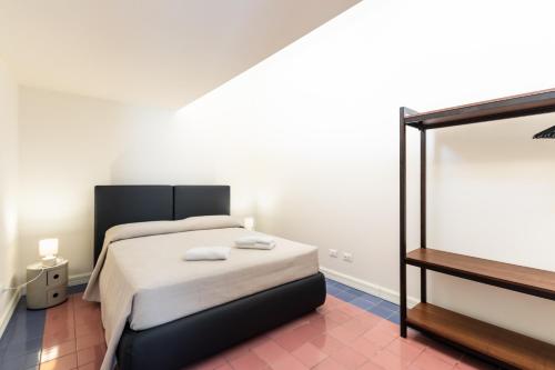 a bedroom with a bed with two towels on it at Palazzo Giangreco Luxury Rooms in Avola
