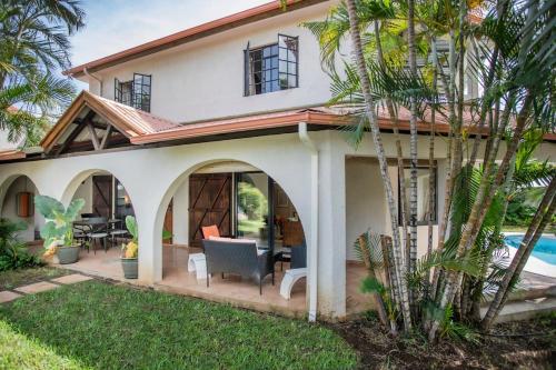 a house with a patio and a swimming pool at Villa Céleste - 4 Bedrooms in Central Tamarin in Tamarin
