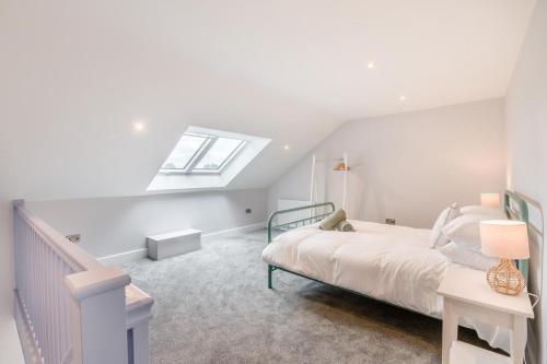 a white bedroom with a bed and a window at 1 Bed in Marishes oc-l32534 in Kirby Misperton